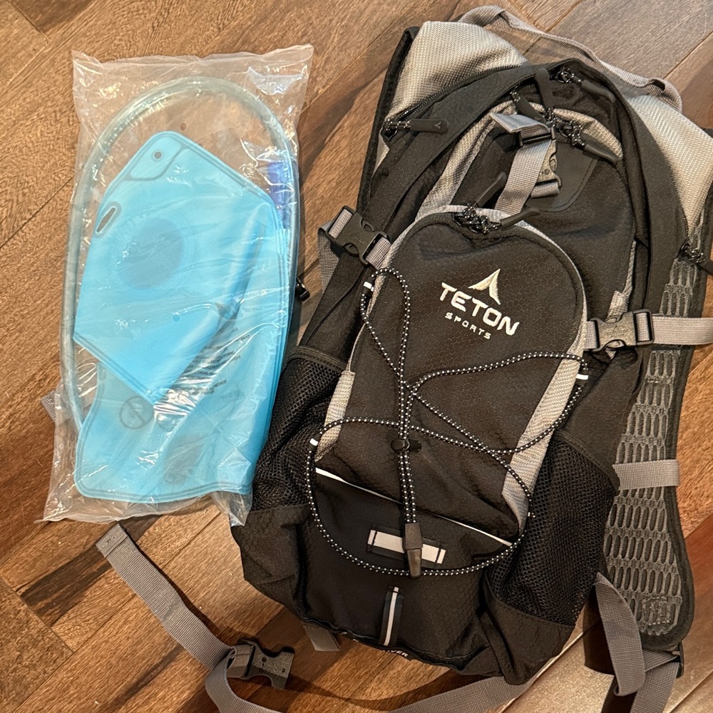 Black hiking pack with hydration bag
